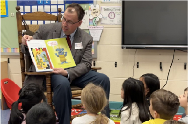 Dr. James Kirsch reading to elementary students for Read Across America.